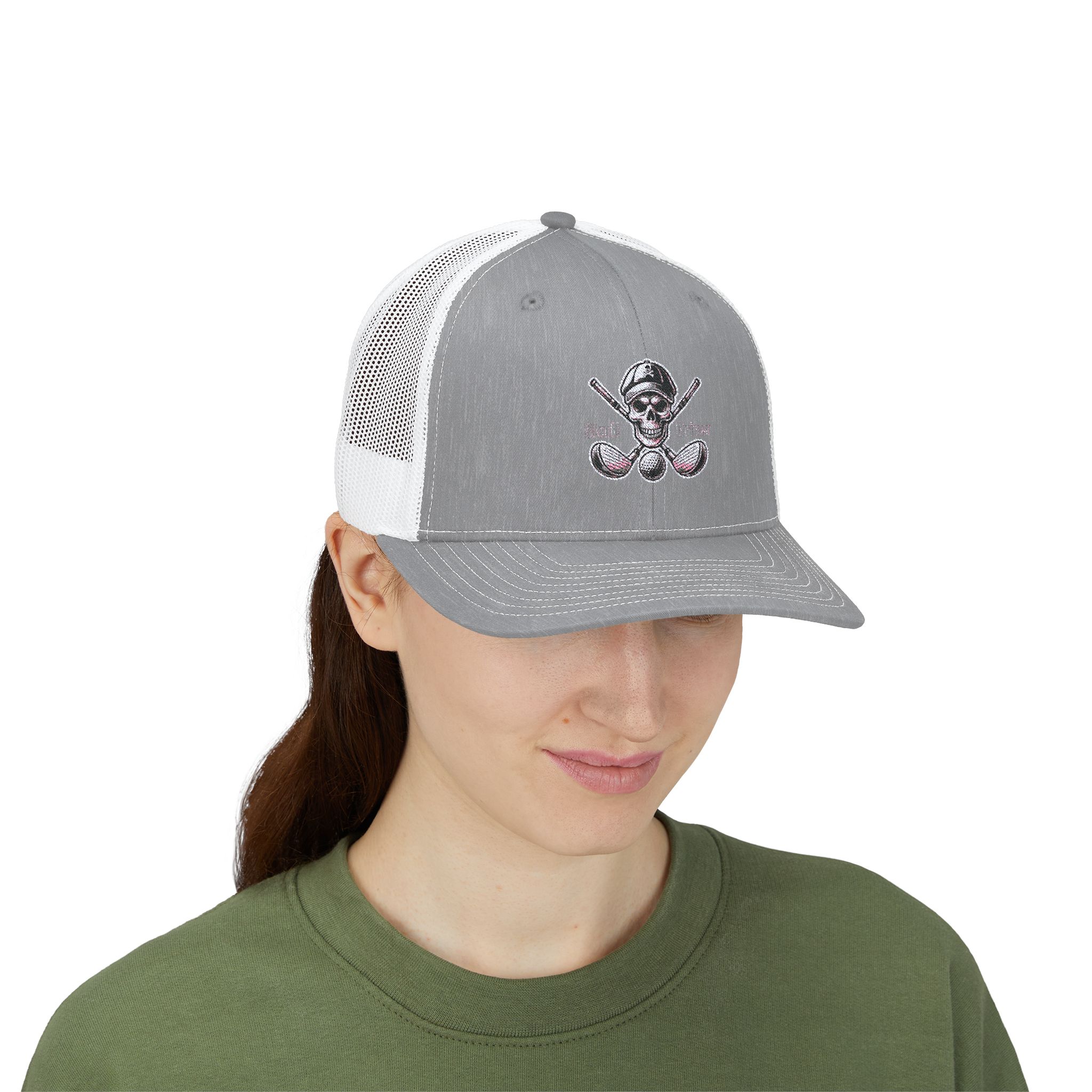 Woman wearing a Skull and Driver trucker cap on a golf course, showcasing stylish golf apparel.